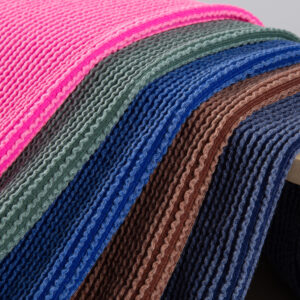 Front-facing shot showing the deep green solid color and continuous raised vertical stripe jacquard surface clearly. Image 2 (Detail - Pattern):